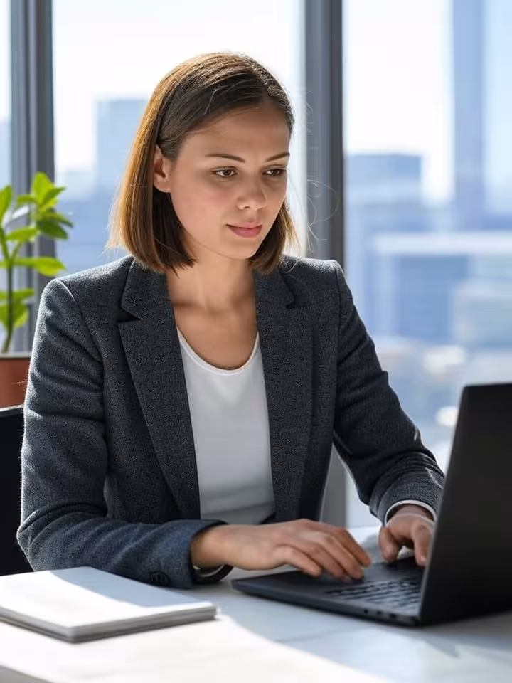 Ambitious young professional woman working on laptop at stylish modern workspace with Santiago citys